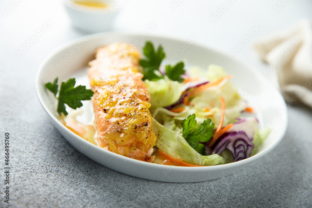 Baked salmon with orange sauce and salad Baked salmon with orange sauce and salad