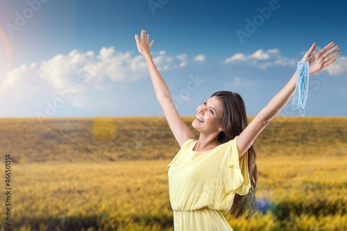 Woman with raising hands on the nature background