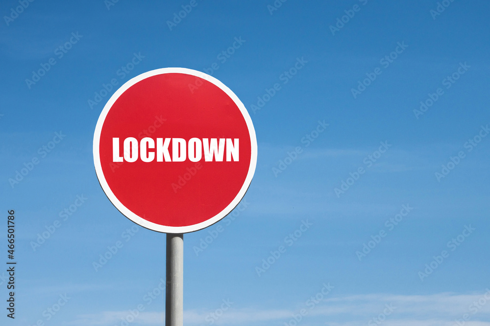 Lockdown sign in red round frame on sky background Lockdown sign in red round frame on sky background