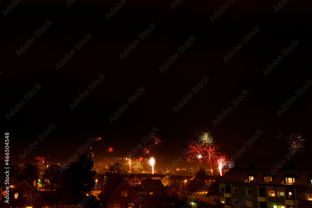 Fireworks on a dark sky over a city