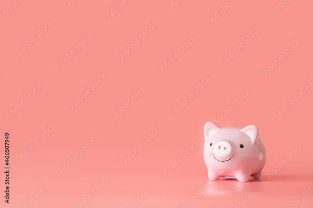 Piggy bank isolated on pink background with copy space. Financial and saving money concept.