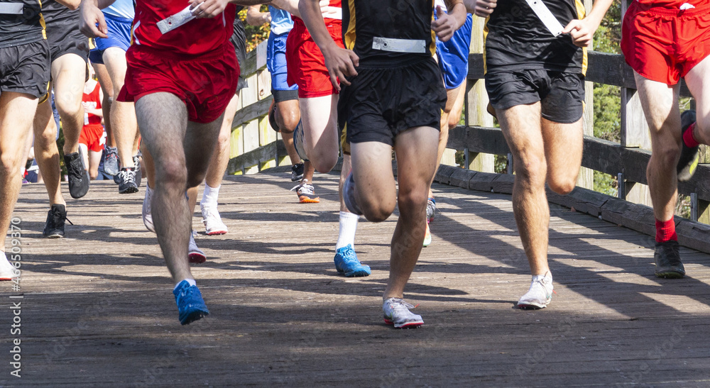 Cross country runners crossing over the bridge at Sunken MEadow