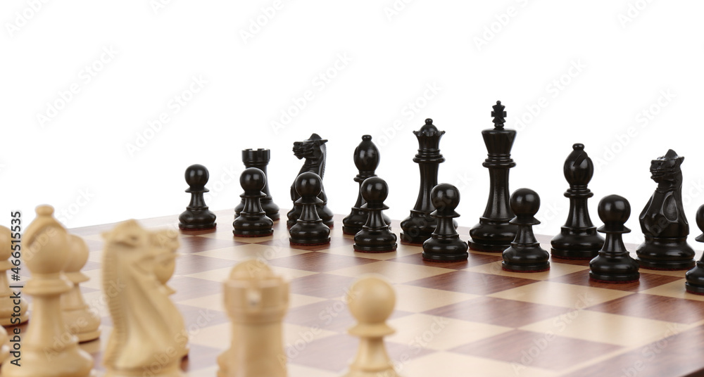Set of black chess pieces on wooden board against white background