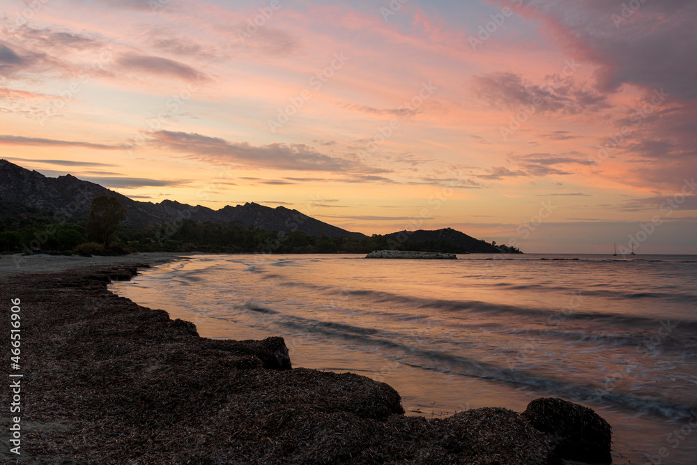 Fototapeta premium The beach at Saint Florent Corsica France at sunset with mountains in the background . holiday destination ..