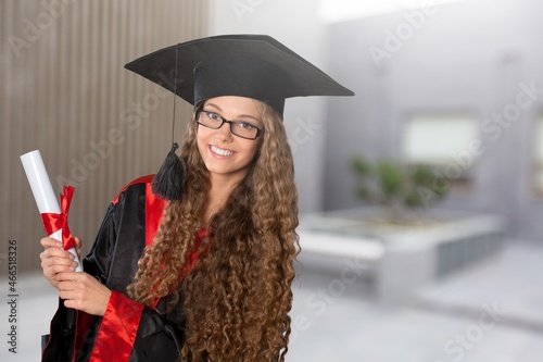 Happy smart student with graduation certificate.