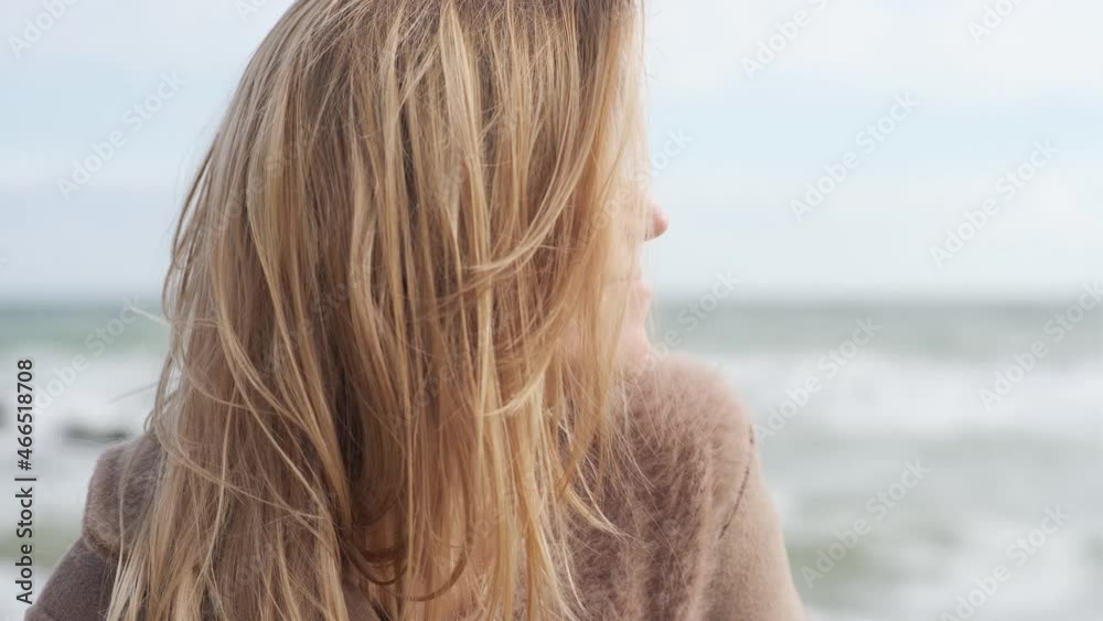 Portrait of romantic blonde woman walking on the beach in autumn sunny day Portrait of romantic blonde woman walking on the beach in autumn sunny day