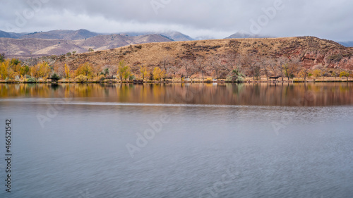 fishing lake with picnic shelters at foothills of Colorado Rocky Mountains  calm fall evening scenery at Watson Lake State Wilderness Area