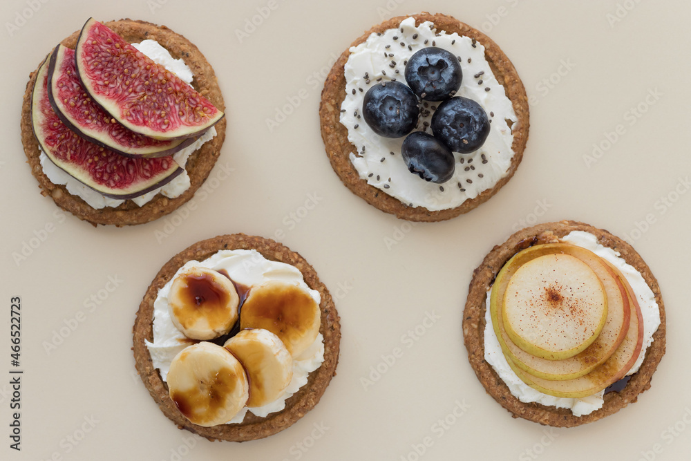 Oat cakes with different toppings on beige background. Healthy dietary snack. flat lay