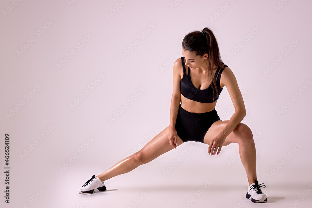 Concentrated Caucasian Fit Female In Sportswear Doing Lunges In Studio On Pink Background, Portrait Of Fit Lady Engaged In Sport, Weight Loss, Workout. Attractive Brunette Is Exercising