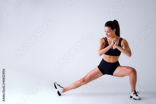 Healthy Caucasian Fit Female In Sportswear Doing Lunges In Studio On White Background, Portrait Of Fit Lady Engaged In Sport, Weight Loss, Workout. Attractive Brunette Is Exercising