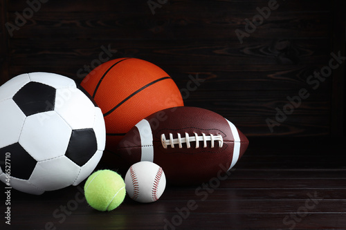 Set of different sport balls on wooden table. Space for text