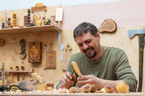 Craftsman making wooden spoons and other items in his workshop