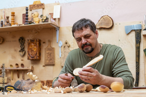Craftsman making wooden spoons and other items in his workshop