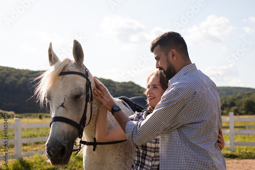 Couple and white horse at the ranch © oksix