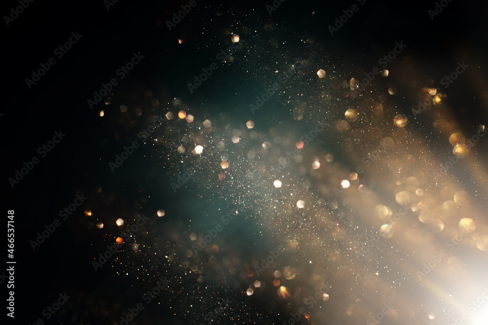 background of abstract gold and black glitter lights. defocused background of abstract gold and black glitter lights. defocused