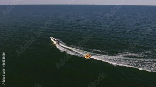 Wallpaper Mural Aerial shot of  inflatable ring with people pulled by a motorboat in the Black Sea    Torontodigital.ca
