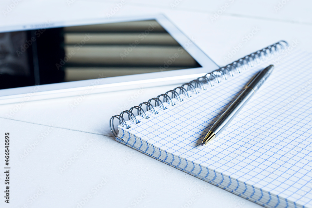 Abstract office background - pen, notepad and tablet on a wooden background. Abstract office background - pen, notepad and tablet on a wooden background.