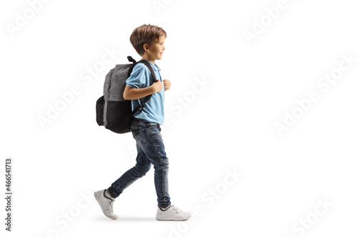 Full length profile shot of a boy with a backpack walking photo