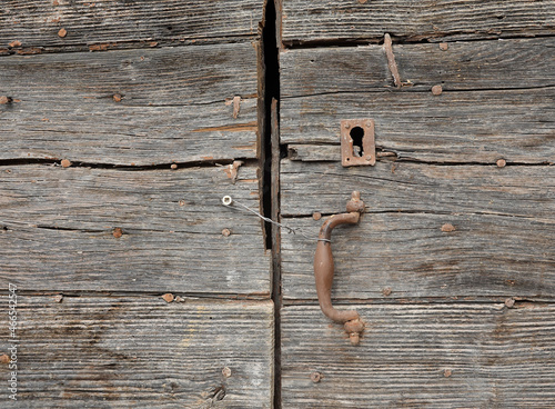 Old wooden door with its lock.