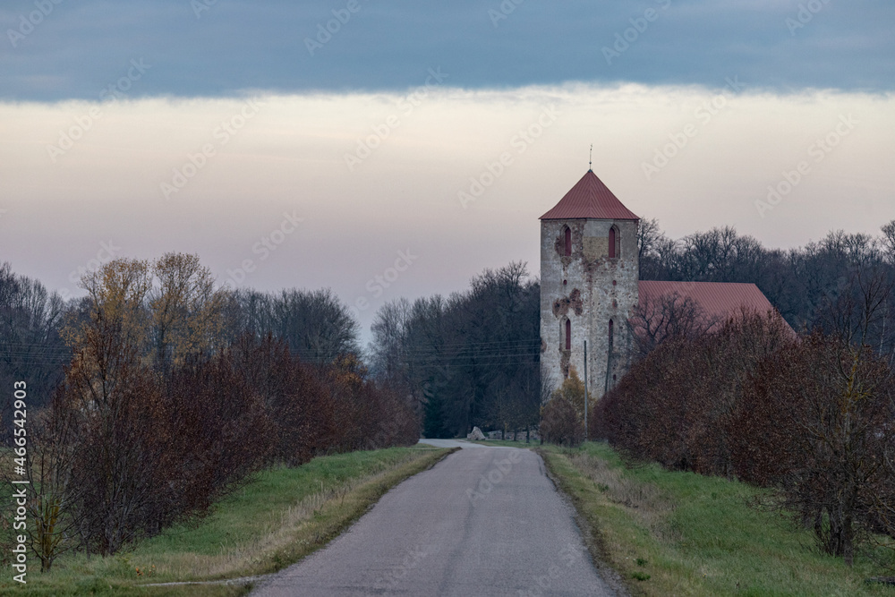 old church on road side, dark gloomy vintage style picture. Bright country road, great perspective, vignette