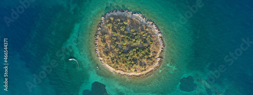 Aerial drone wide photo of small islet of Agios Athanasios with small landmark church next to famous city of Itea, Fokida, Greece photo