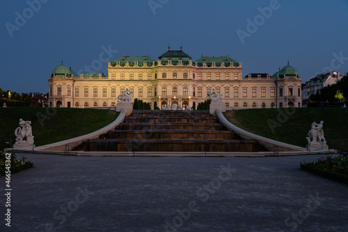 Famous Belvedere castle (Schloss Belvedere) surrounded by gardens with fountains and classic statues at night, Vienna, Austria