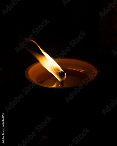 Flame of a candle on a grave. All Saints day. Votive candle on a dark background. All Saints Day 1st November. All Souls Day 2nd November. The Day of The Dead.
