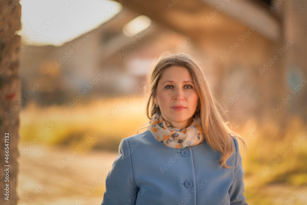 Portrait of a young beautiful blonde girl in a blue coat, close-up. Portrait of a young beautiful blonde girl in a blue coat, close-up.