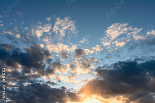 blue sky with clouds beautifully illuminated by the setting sun as a natural background