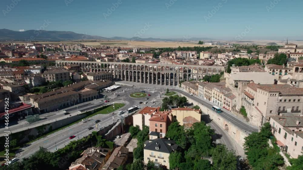 Aerial drone point of view cityscape and medieval ancient Roman Aqueduct, road traffic in busy street near famous landmark of Segovia, Castile and Leon, Spain. UNESCO heritage, travel, tourism concept Aerial drone point of view cityscape and medieval ancient Roman Aqueduct, road traffic in busy street near famous landmark of Segovia, Castile and Leon, Spain. UNESCO heritage, travel, tourism concept