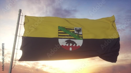 Saxony-Anhalt flag, Germany, waving in the wind, sky and sun background photo