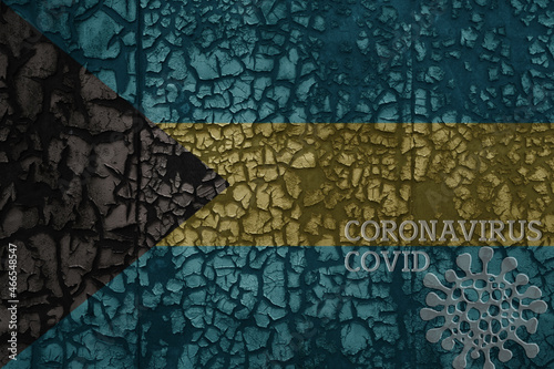 flag of bahamas on a old metal rusty cracked wall with text coronavirus, covid, and virus picture.