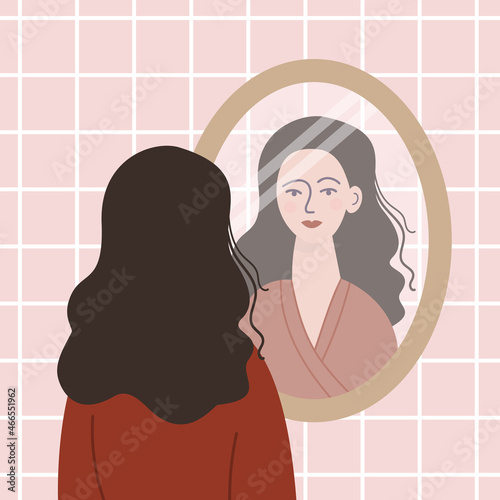 Woman looking at herself in the mirror.