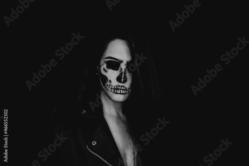 A girl with skull make up. Halloween happy party.