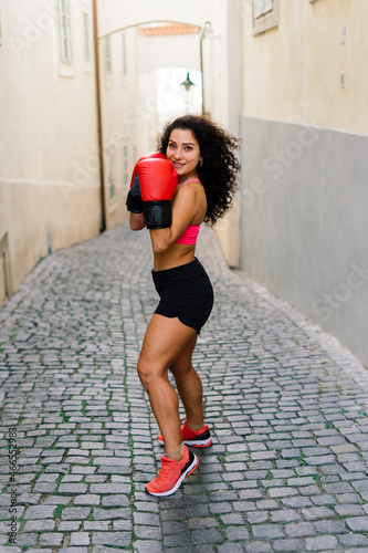 Woman power, self defence concept. Portrait of attractive serious fit boxer, ready for fight photo