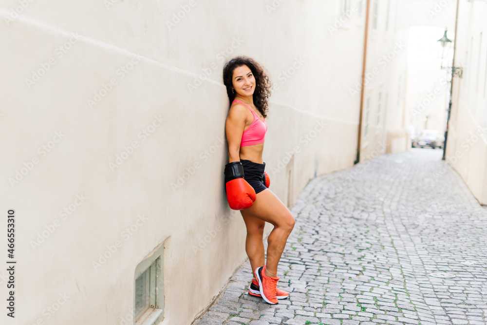 Woman power, self defence concept. Portrait of attractive serious fit boxer, ready for fight Woman power, self defence concept. Portrait of attractive serious fit boxer, ready for fight