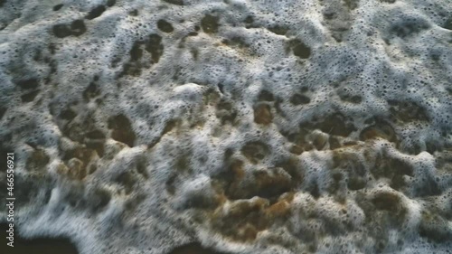 Sea waves breaking on sandy beach slow motion