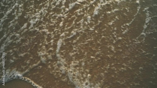 Sea waves breaking on sandy beach slow motion