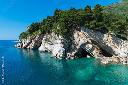 Rock cliff and blue sky and adriatic sea in Petrovac, Montenegro