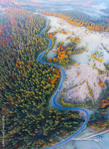 Aerial photo of beautiful mountain Krivopol pass Carpathians, Ukraine. Drone filmed an alpine landscape with coniferous and beech forests, houses, around a winding serpentine road photo