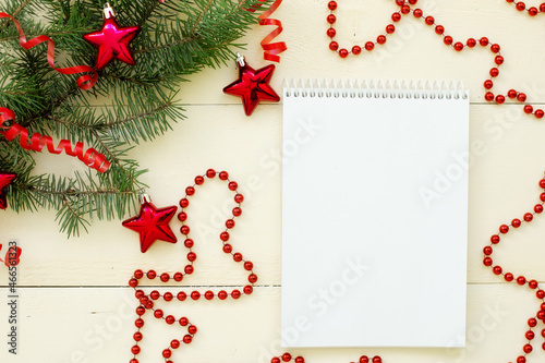 Christmas and New Year background. Christmas pine, spruce, notebook. Candy stick, white wooden background.