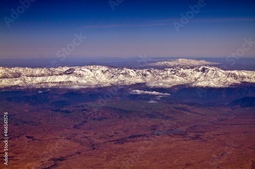 Red dust and snow covered mountains Atlas in Morocco