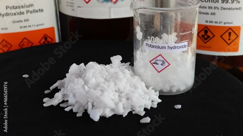 Potassium hydroxide flake on black background, chemistry in the laboratory