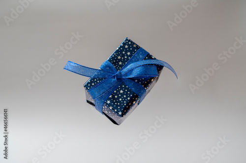 Gift blue box with blue bow. Christmas sinlge gift box isolated.