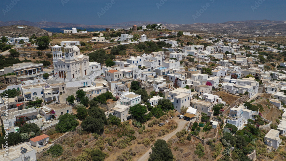 Aerial drone photo of beautiful whitewashed village of Tripiti built uphill with great views to Aegean sea and main village of Milos island, Cyclades, Greece