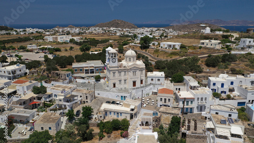 Aerial drone photo of beautiful whitewashed village of Tripiti built uphill with great views to Aegean sea and main village of Milos island, Cyclades, Greece © aerial-drone