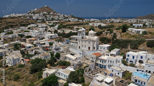 Aerial drone photo of beautiful whitewashed village of Tripiti built uphill with great views to Aegean sea and main village of Milos island, Cyclades, Greece © aerial-drone