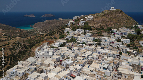 Aerial drone photo of main village of Plaka, main village of Milos island featuring uphill castle and scenic views to Aegean sea, Cyclades, Greece © aerial-drone