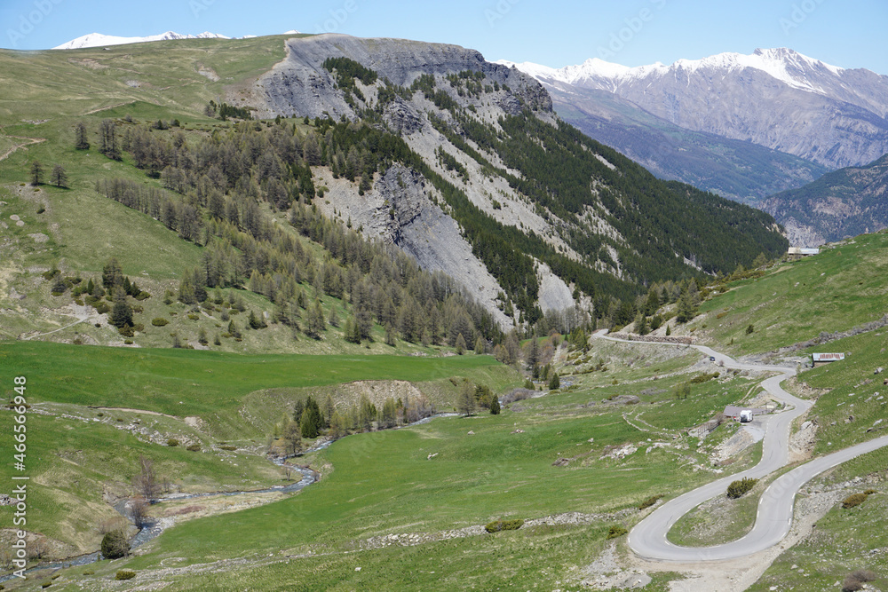 landscape in the mountains in spring with meandering road up col de la bonette alps france