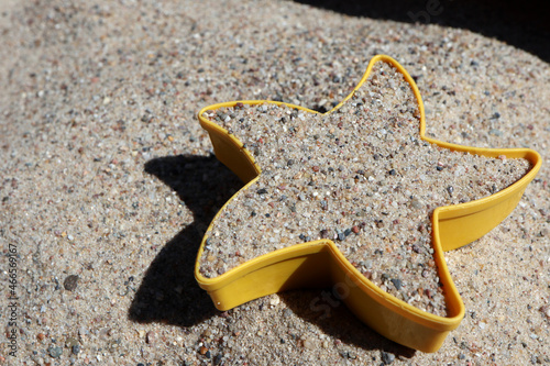 sandbox form in sand at the beach in sunny summer vacation